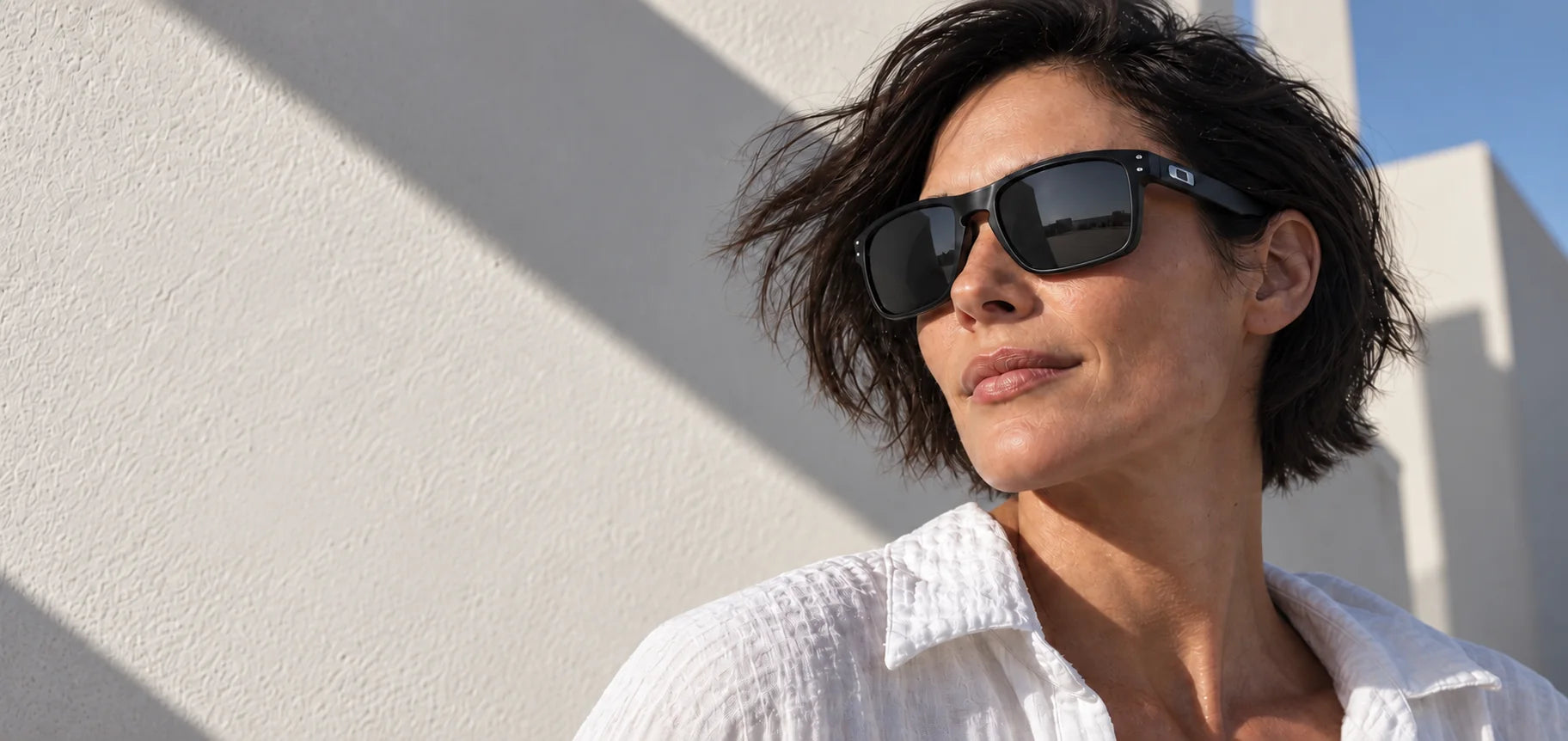 Woman wearing black rectangular sunglasses in natural daylight